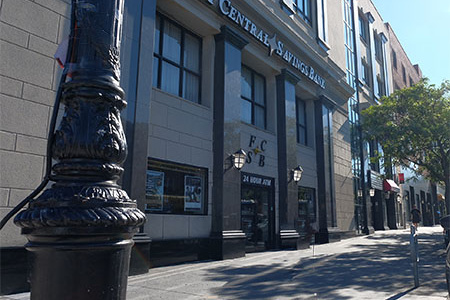 Picture of the exterior of First Central Savings Bank's Astoria Branch. First Central Savings Bank sign shown and FCSB logo with 24 hour ATM above the door.